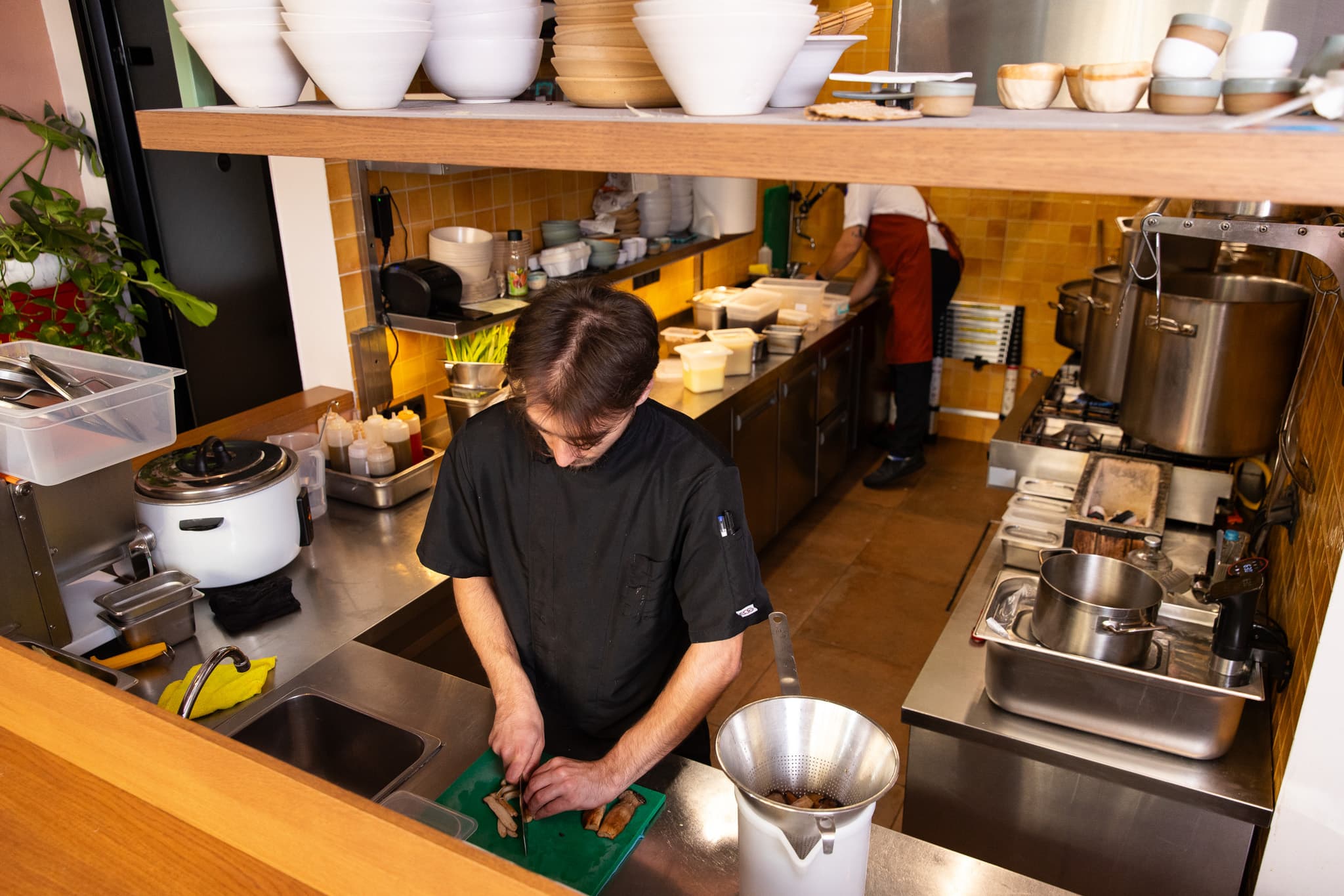 Chef prepping at the Ramen Tales kitchen counter
