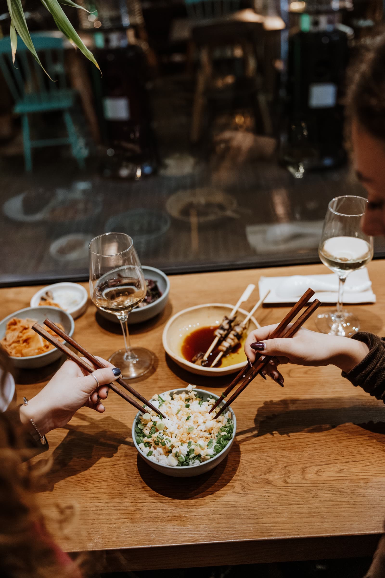 Two people sharing a rice bowl