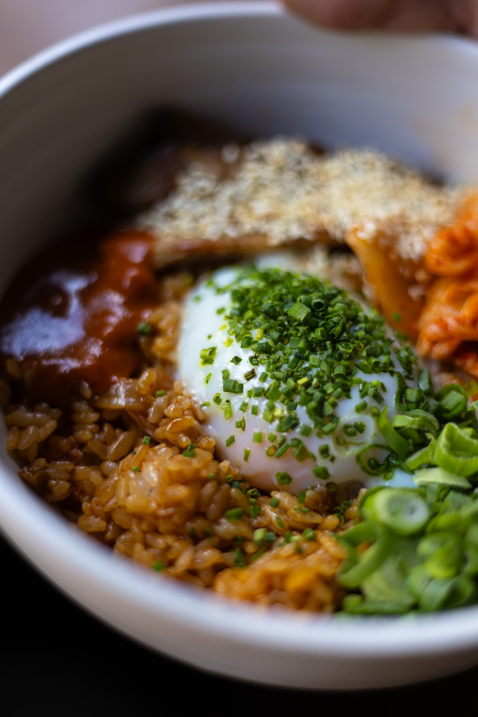 Close-up of a rice bowl with soft egg and kimchi