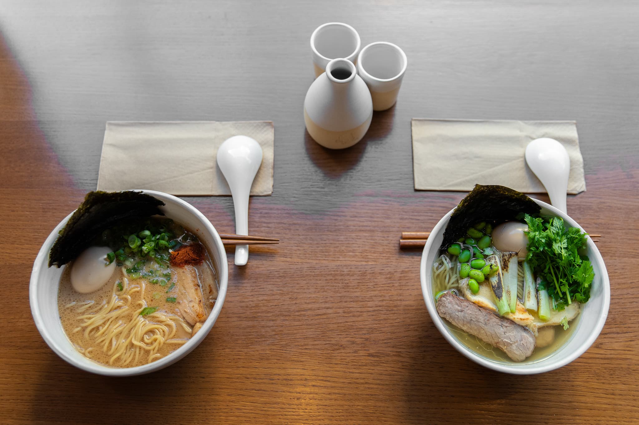 Two ramen bowls with a sake set